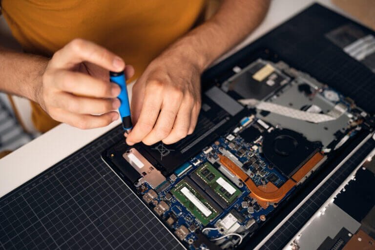 Man working on circuit board with tools.