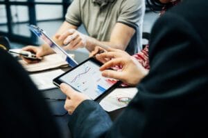 Employees working together on tablets and phones.