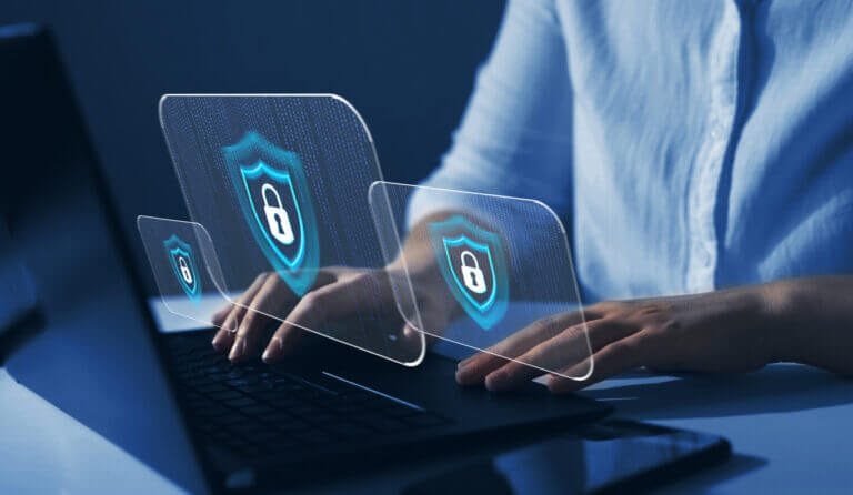 IT consultant reviewing cybersecurity on a computer.