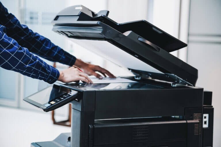 Employee making a photo copy in a printer.