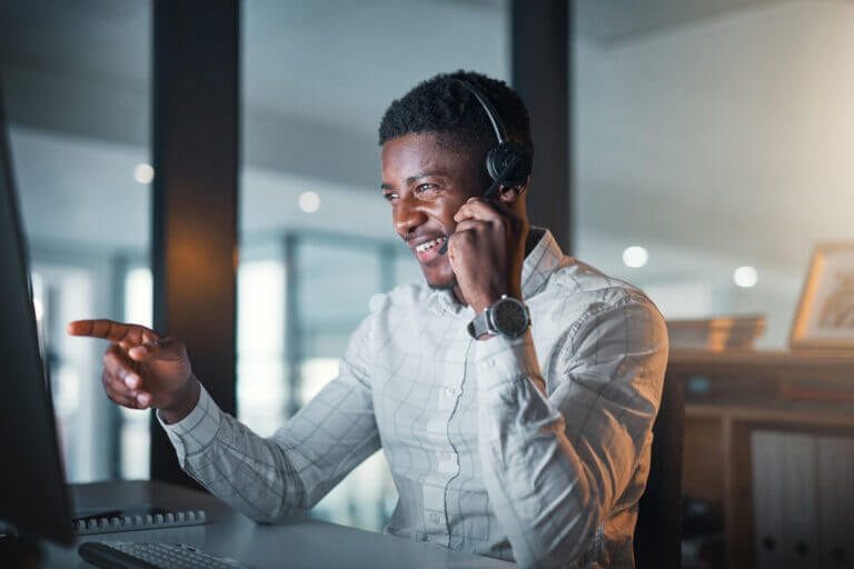 IT support staff on a phone call with client regarding IT managed services.