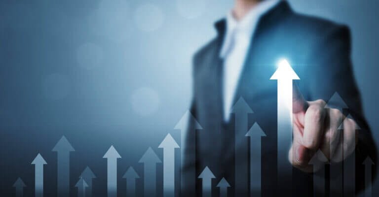 Business associate touching a graph on a glass screen.