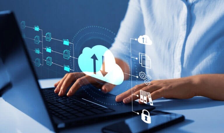 Woman working on a laptop with open cybersecurity files.