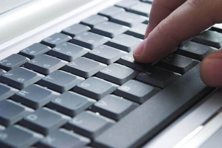 IT consultant working on a laptop.