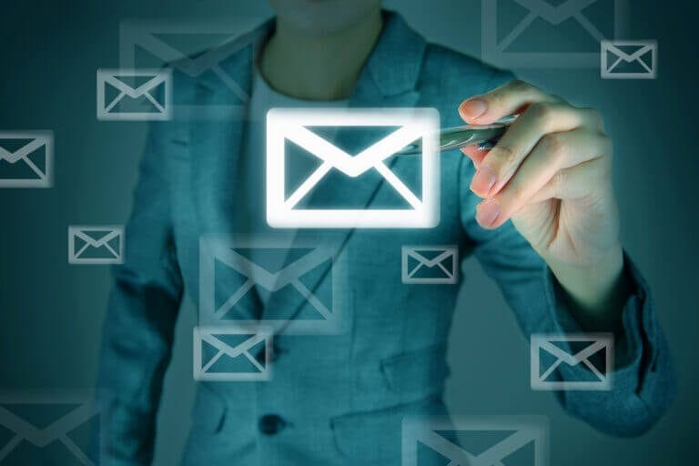 Microsoft Outlook email icons on a digital screen with woman IT security consultant.