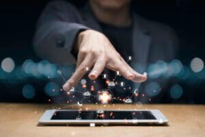 Hand controlling mobile icons floating in the air.