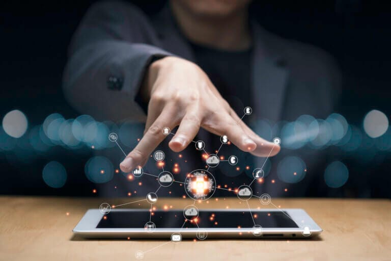 Hand controlling mobile icons floating in the air.
