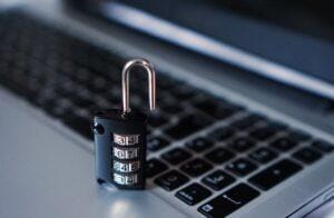 Open lock sitting on a laptop.