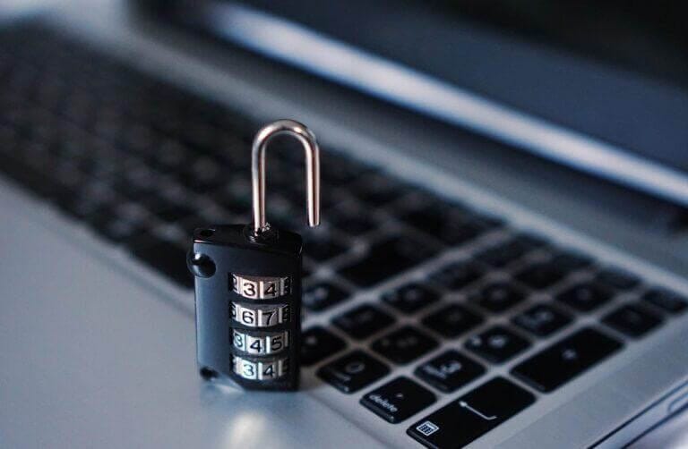 Open lock sitting on a laptop.