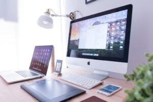 Light and bright office with computer and laptop on a desk.