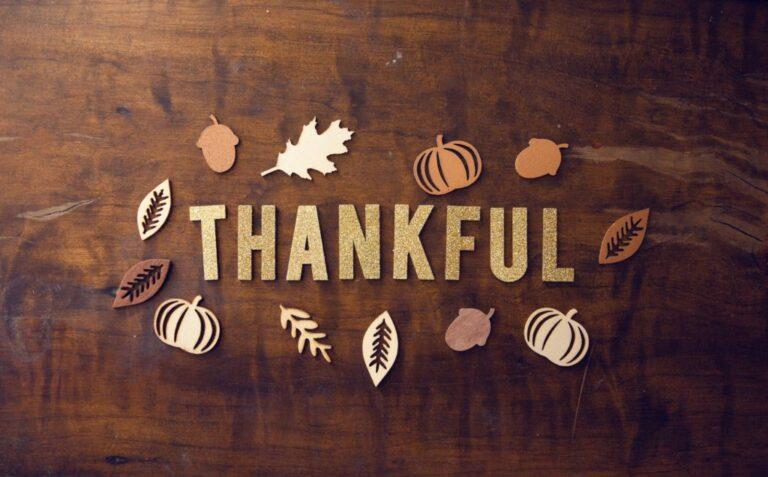 Thankful spelled out on a wood table.