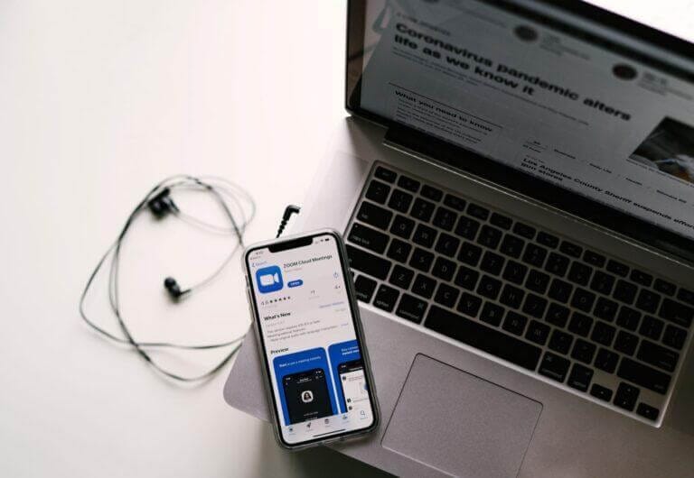 ZoomMeeting app loaded on a mobile device along with a laptop.