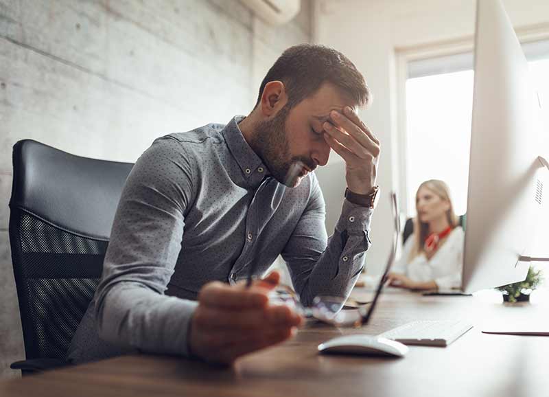 Man in distress while working on computer